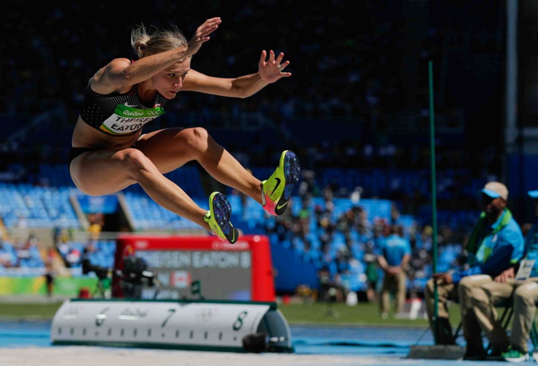 Brianne Theisen-Easton flies in the air during a long jump