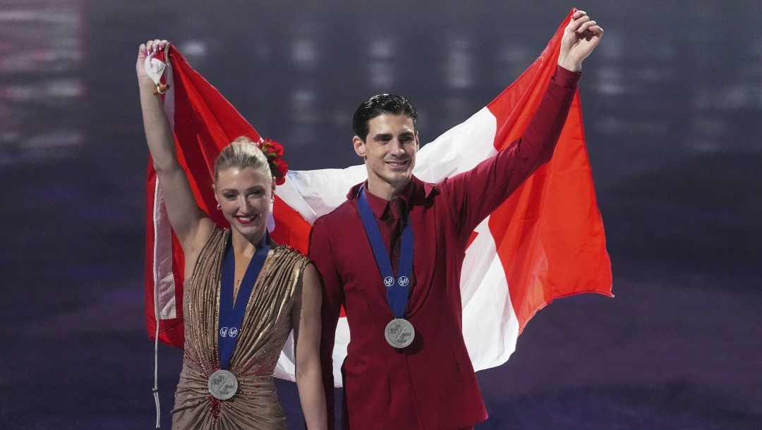 Silver medalists Piper Gilles and Paul Poirier, of Canada, pose for a photos during a medal ceremony for ice dancing at the figure skating world championships,
