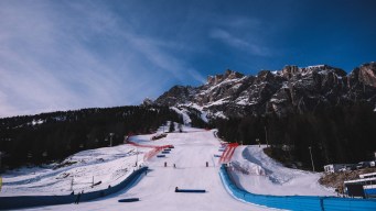 large snowy ski hill under a blue sky