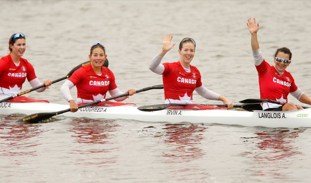 Kayakers wave on the water