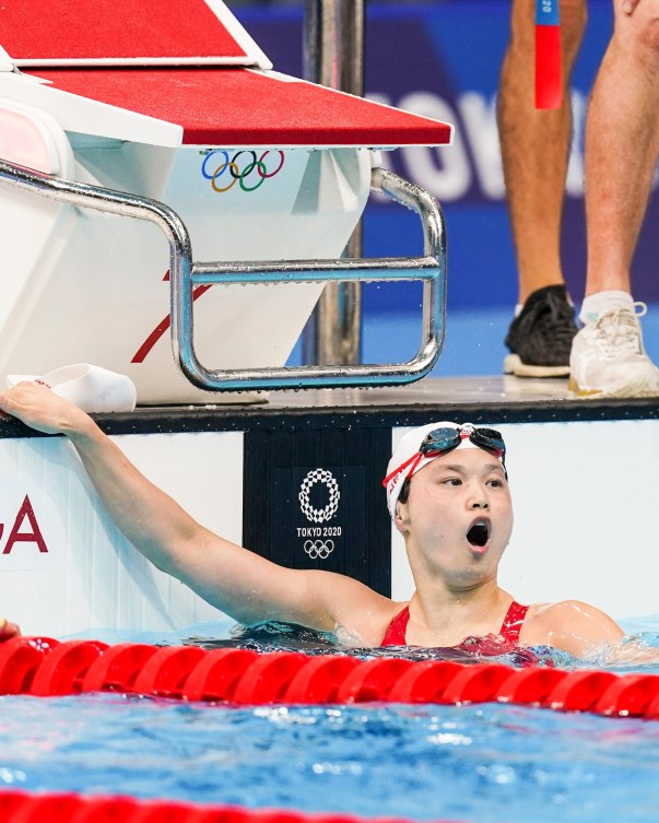 Maggie MacNeil reacts to her winning time in the water